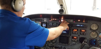 Pilot in Aircraft Cab Adjusting Controls